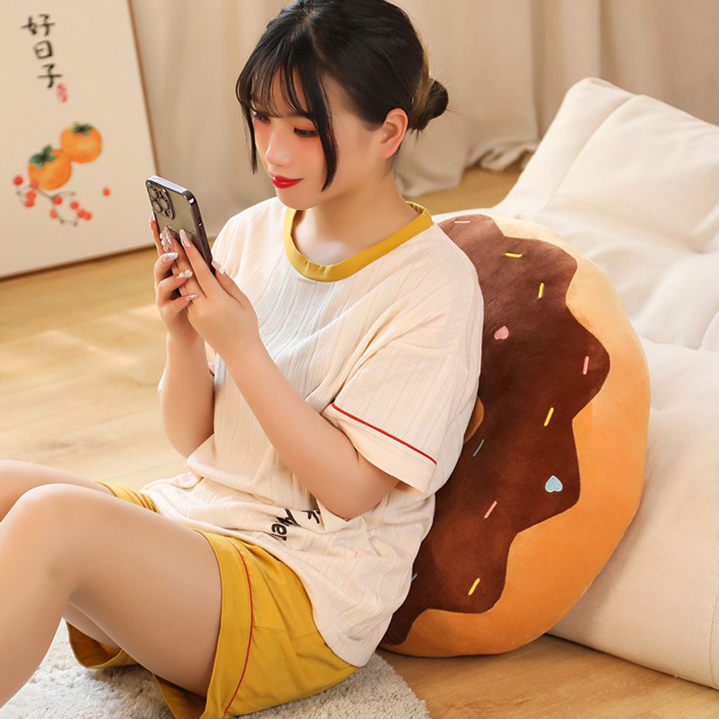 Donut plush pillow used as a cozy back cushion