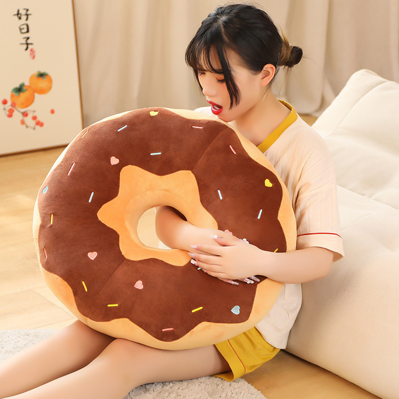 Donut plush pillow used as a soft hugging cushion