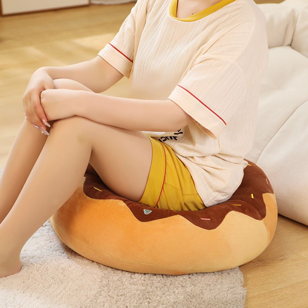 Donut plush pillow used as a soft seat cushion