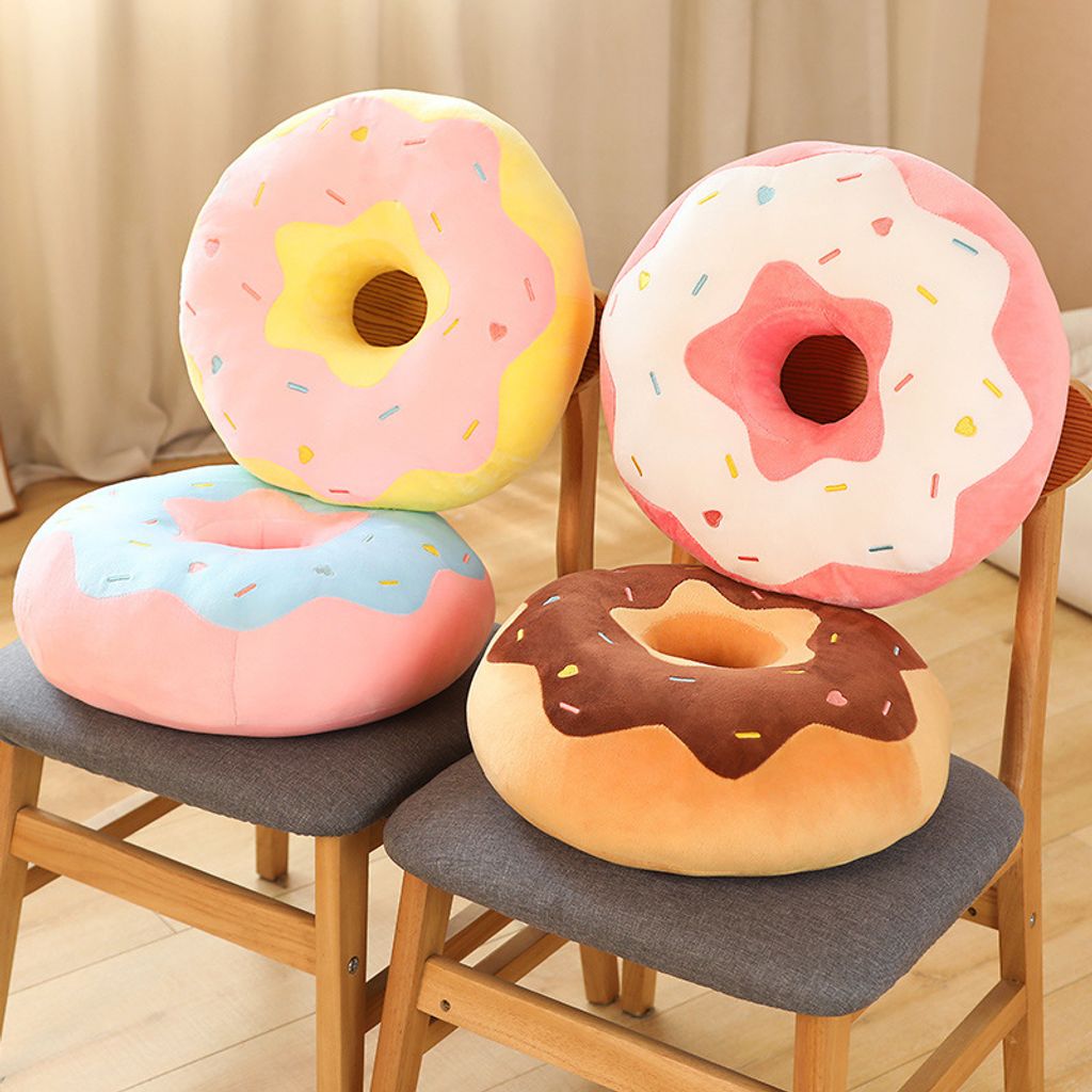 Donut plush pillow displayed on wooden chair for home decor