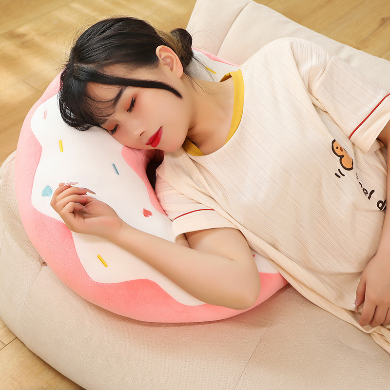 Donut plush pillow used as a cozy sleeping pillow