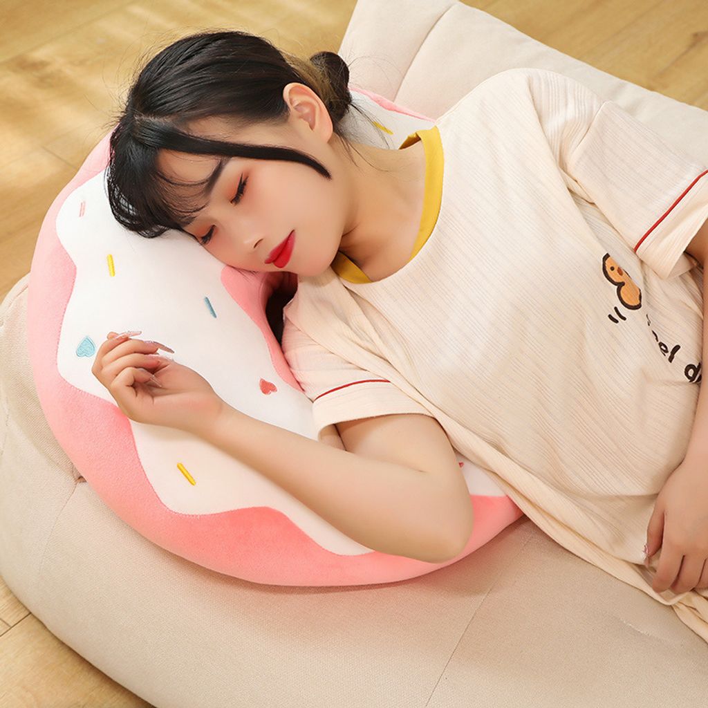 Donut plush pillow used as a cozy sleeping pillow