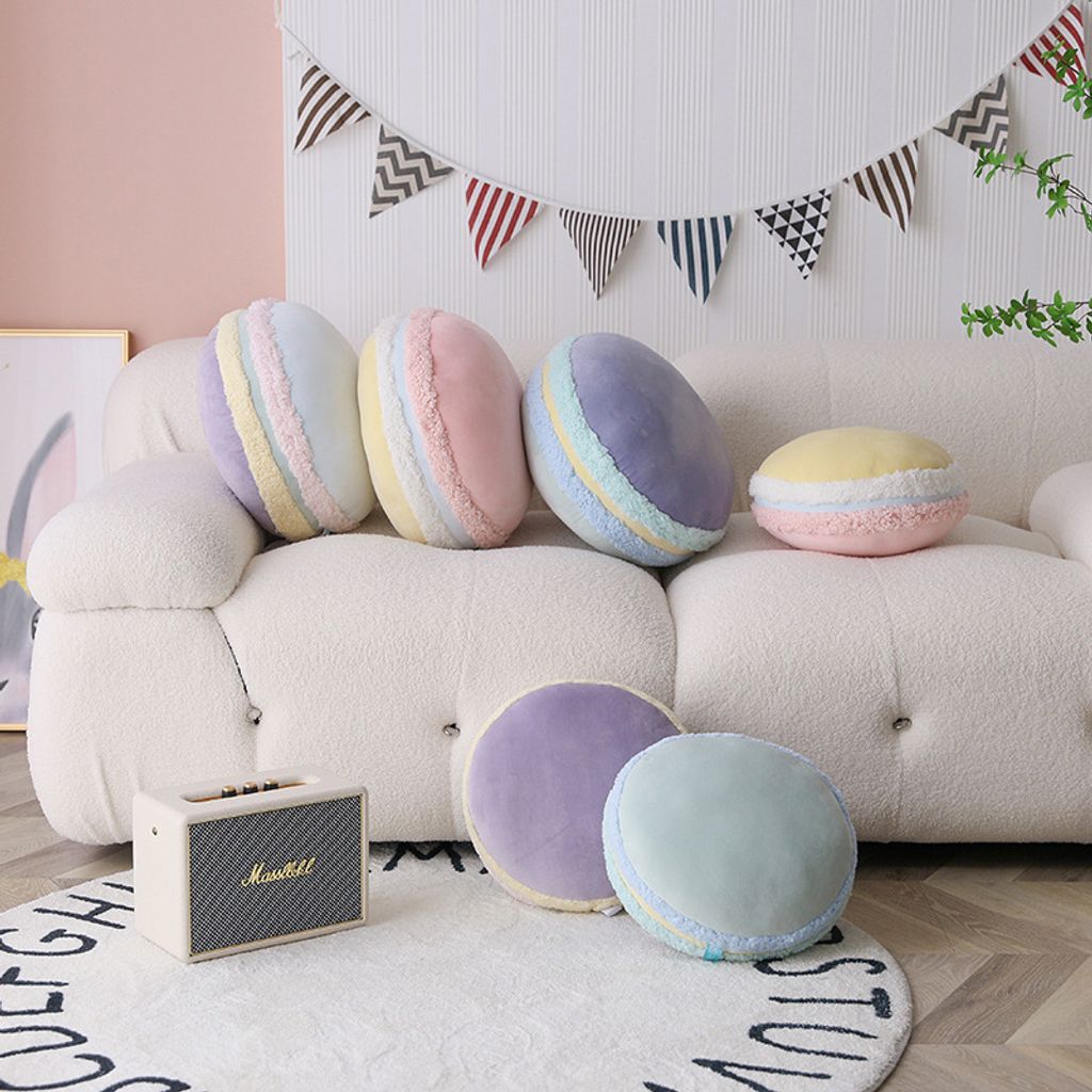 Pastel macaron plush pillows decorating a cozy sofa