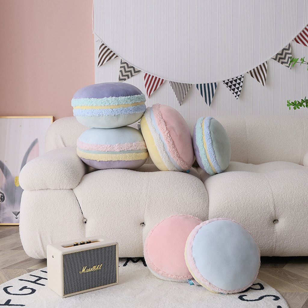 Pastel macaron plush pillows decorating a cozy sofa