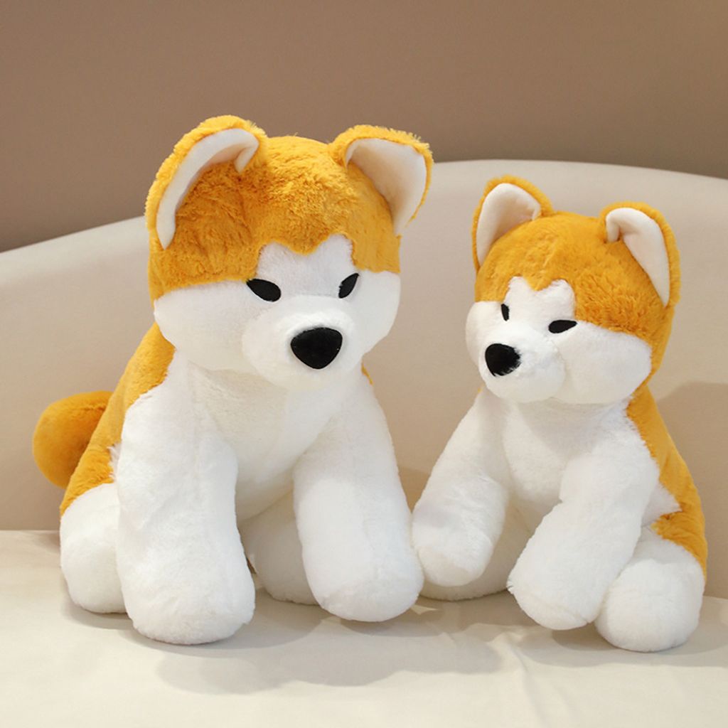 Cute Akita Inu sitting plush toys displayed on a sofa