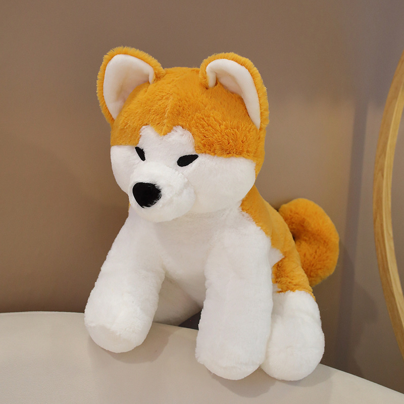 Cute Akita Inu sitting plush toy on a sofa