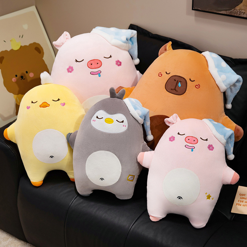 Sweet dreams animal plush pillow collection featuring capybara, duck, pig, and penguin designs