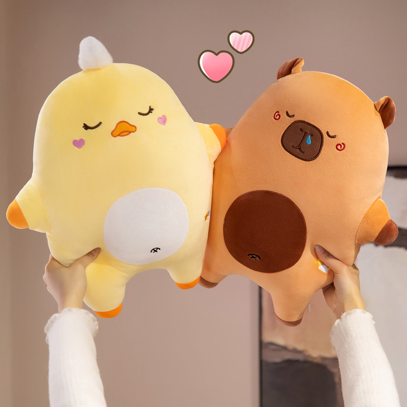 Sweet dreams animal plush pillow featuring duck and capybara designs