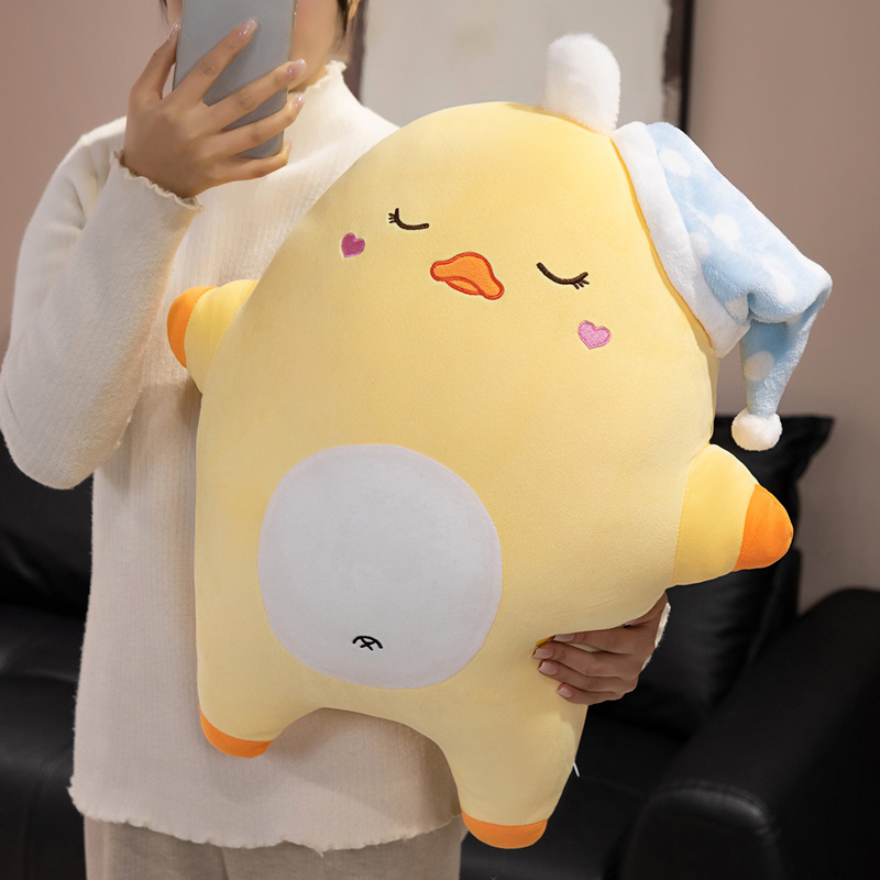 Sweet dreams duck plush pillow held in arms for size reference