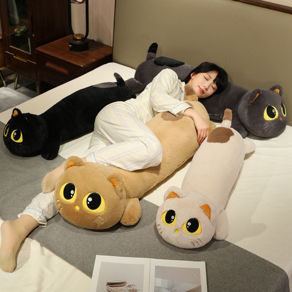 Multiple cute lying cat long plush pillows used for relaxing and sleeping on bed