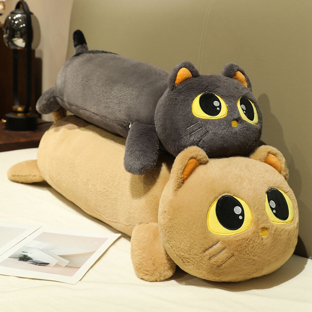 Two cute lying cat long plush pillows stacked on bed for display