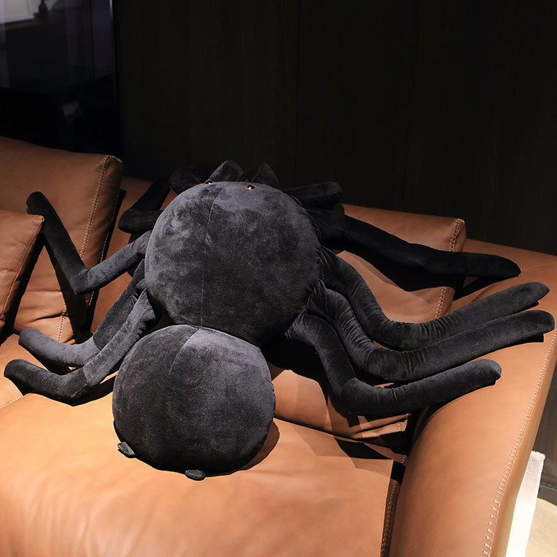 Giant spider plush pillow top view on sofa