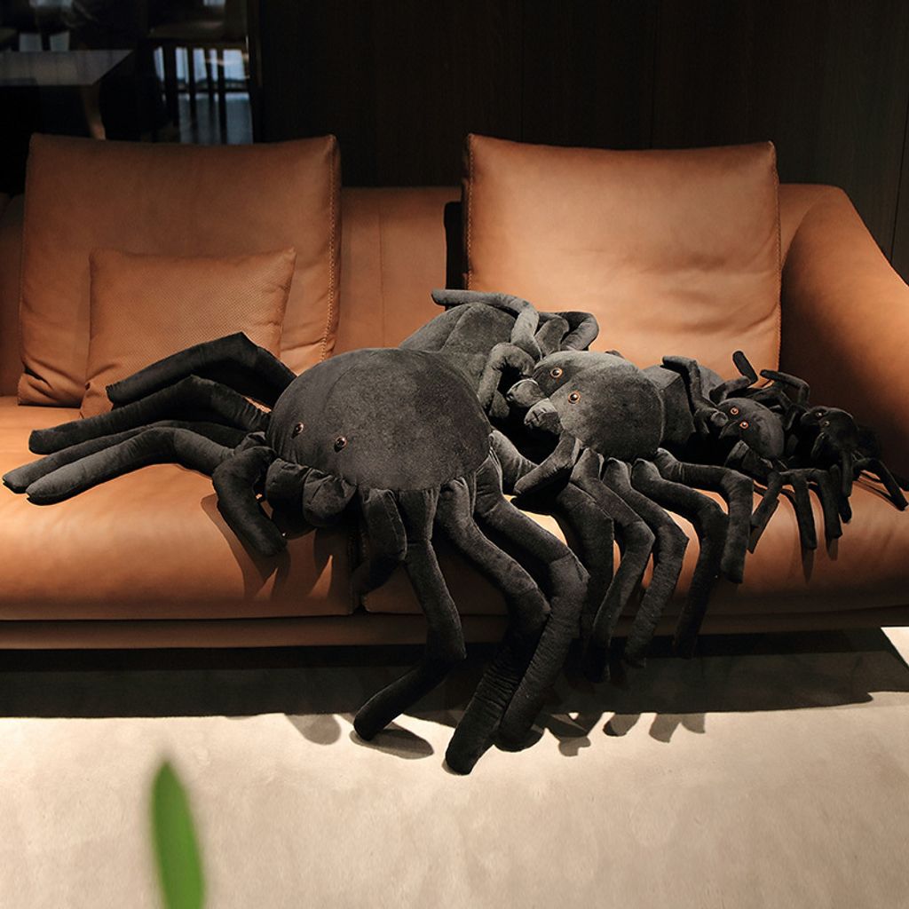 Giant spider plush pillow size comparison on sofa