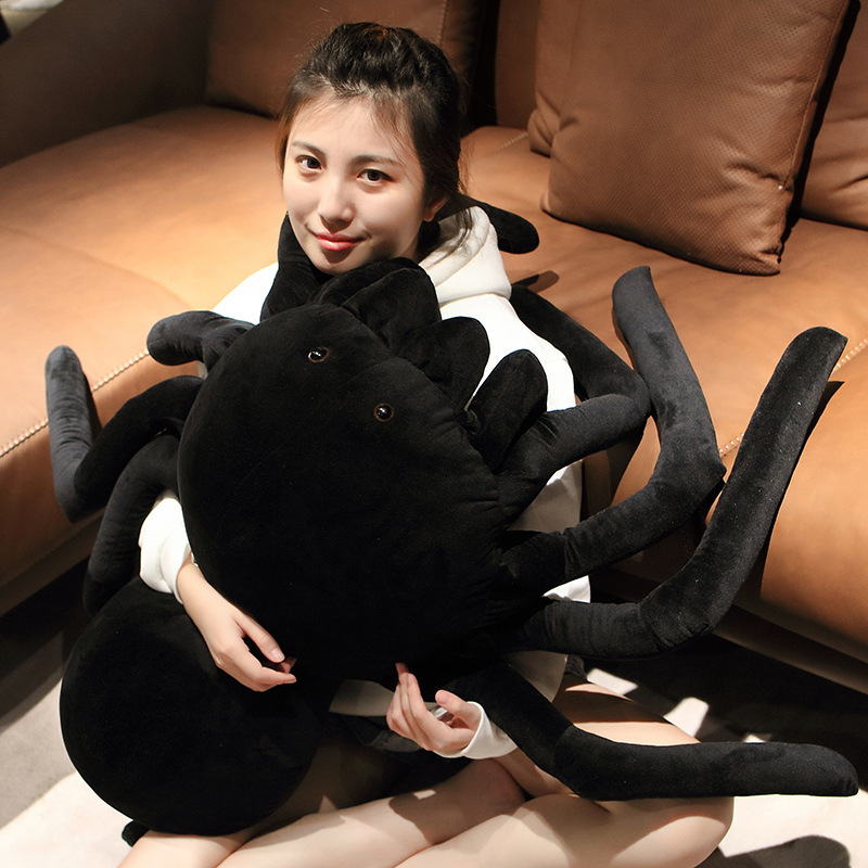 Giant spider plush pillow used as a hugging pillow