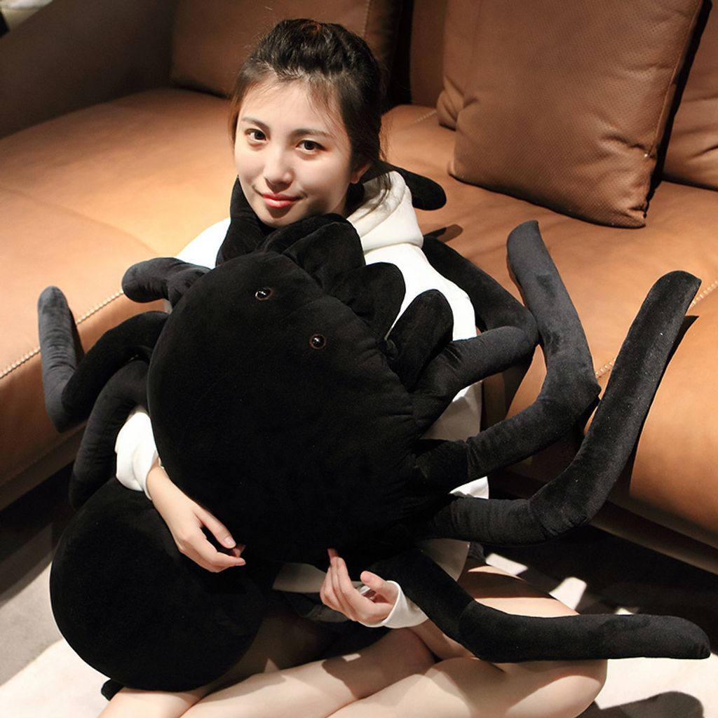 Giant spider plush pillow used as a hugging pillow