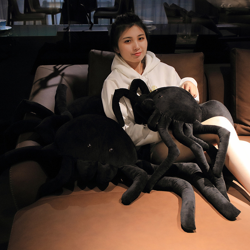 Giant spider plush pillow size comparison on sofa