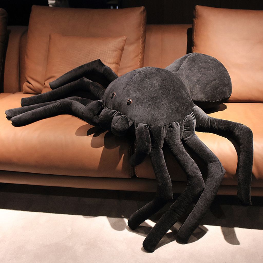 Giant spider plush pillow on sofa