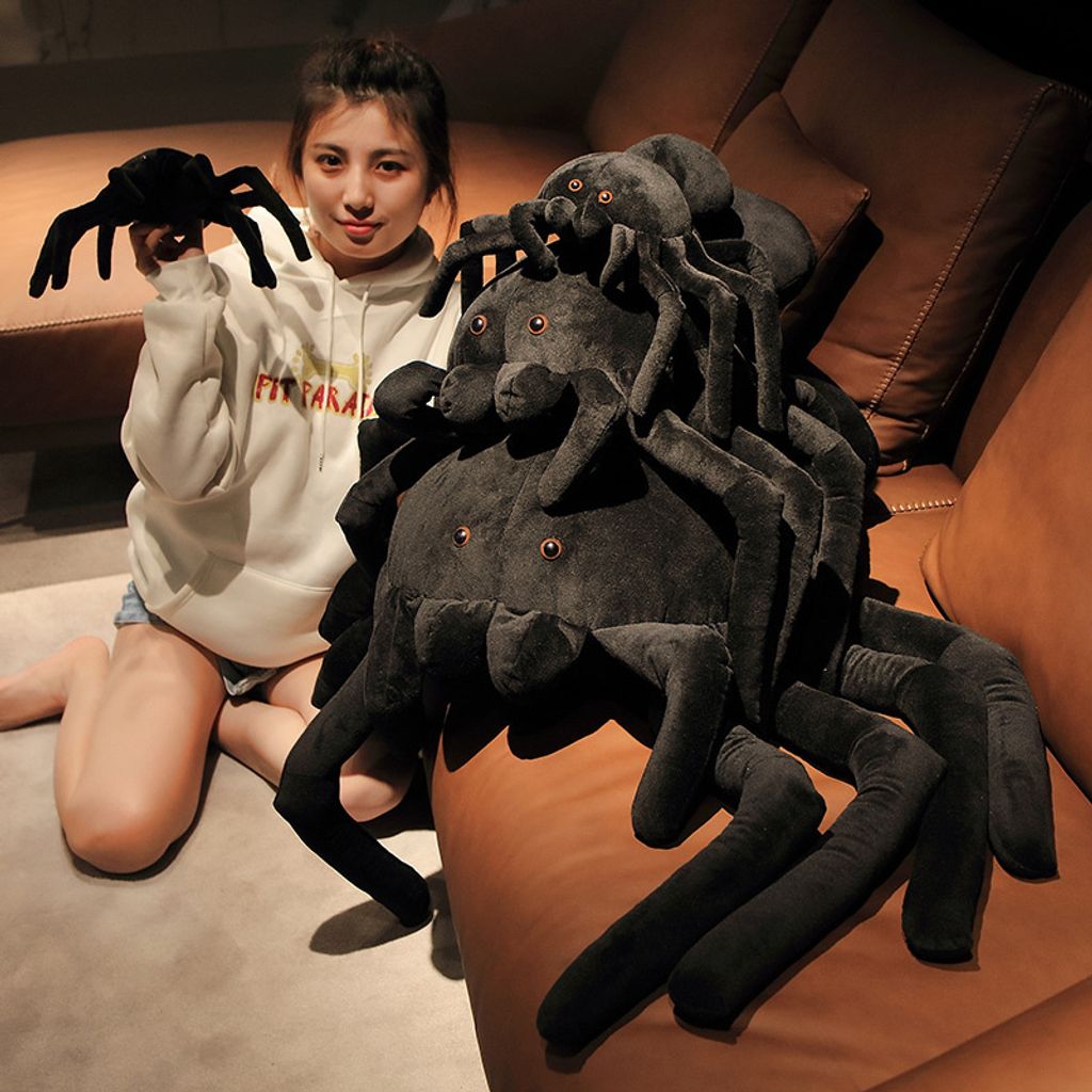 Giant spider plush pillow shown in all four sizes