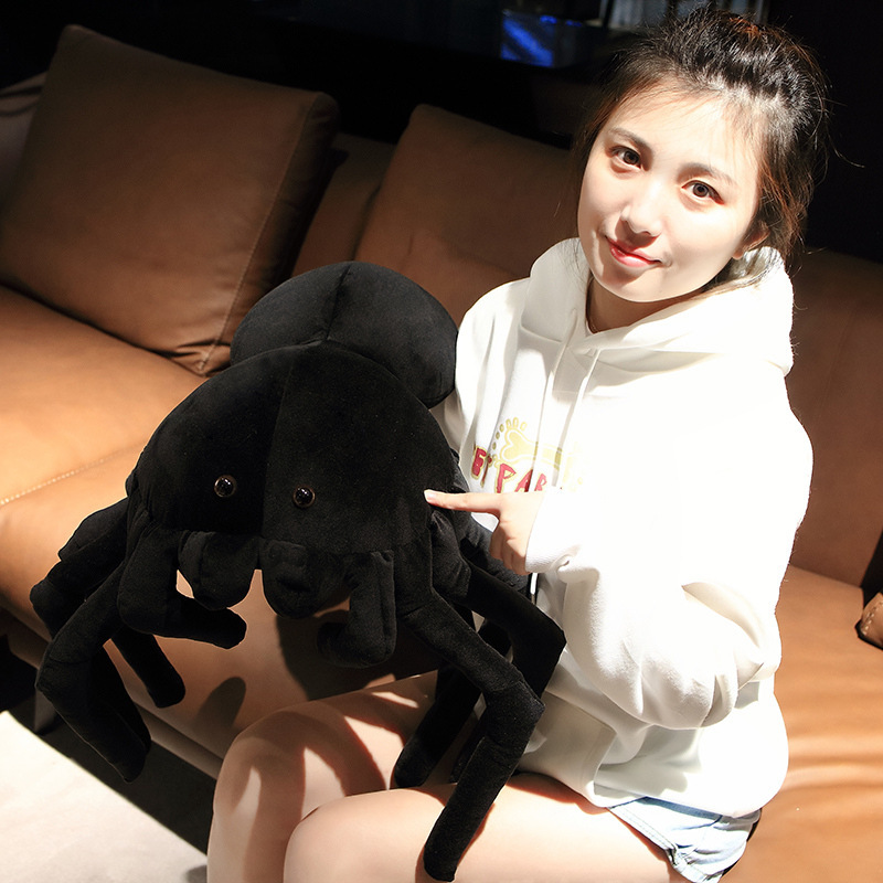 Giant spider plush pillow close up showing face details and soft fabric