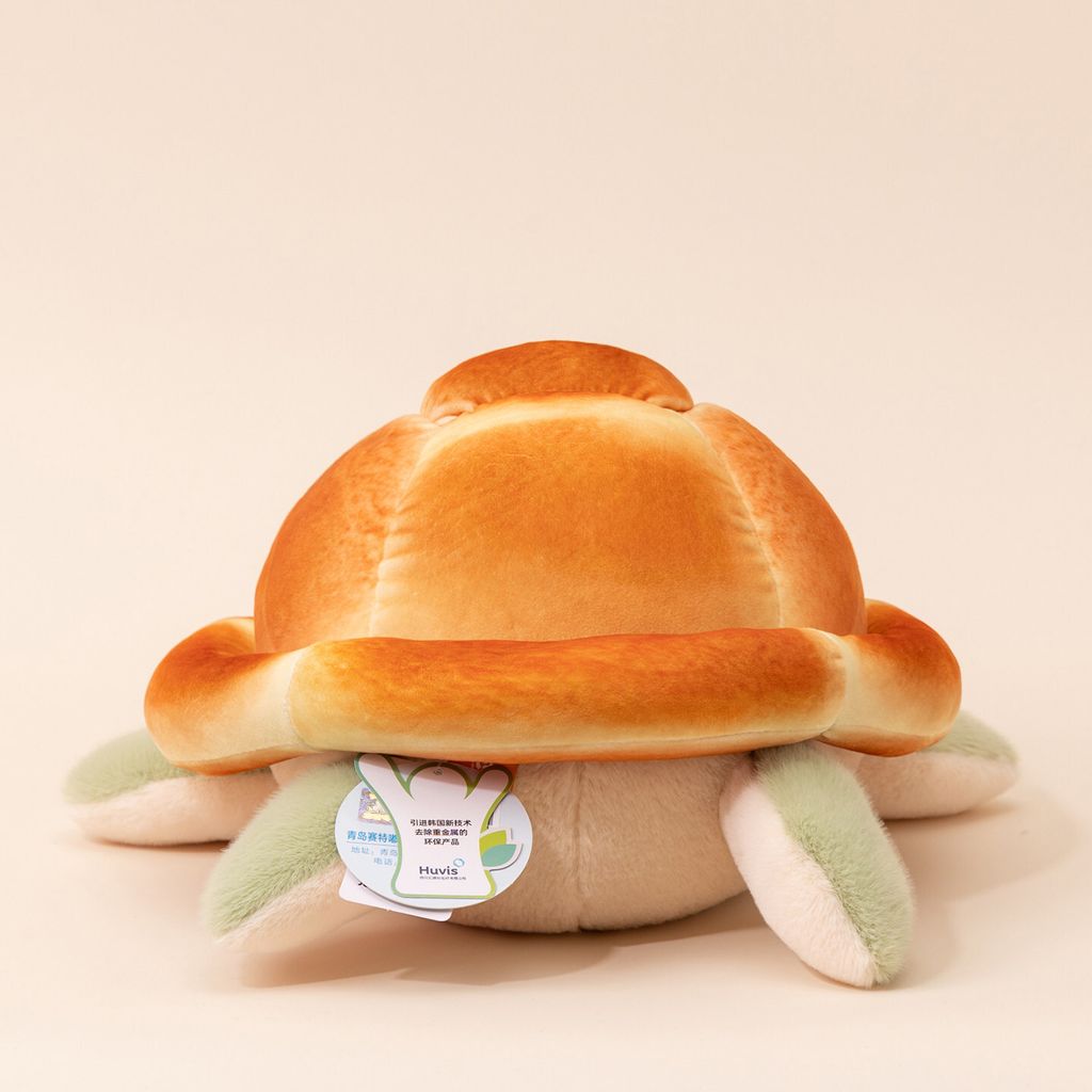 Back view of bread turtle plush toy with soft bread shell and green flippers