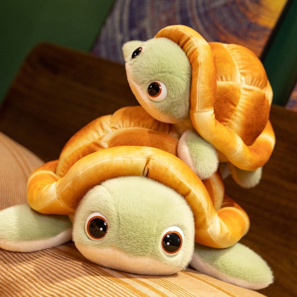 Stacked bread turtle plush toys showing cute green faces, fluffy bread shells, and soft flippers in a cozy room