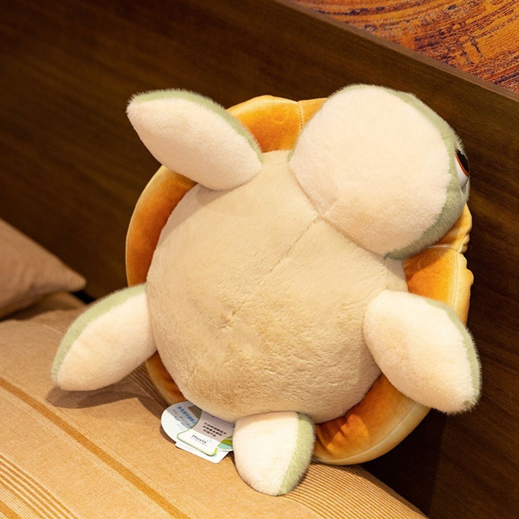 Bread turtle plush toy showing soft beige belly and green flippers from the back view