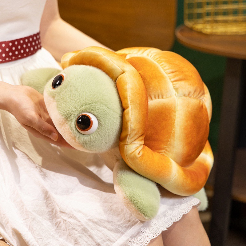 Bread turtle plush toy with soft bread shell and green flippers, shown from a side angle