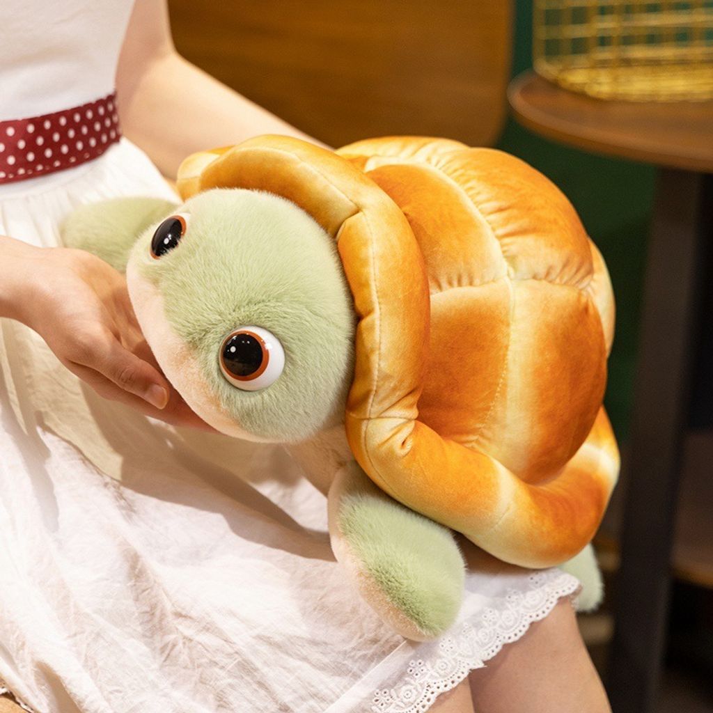 Bread turtle plush toy with soft bread shell and green flippers, shown from a side angle