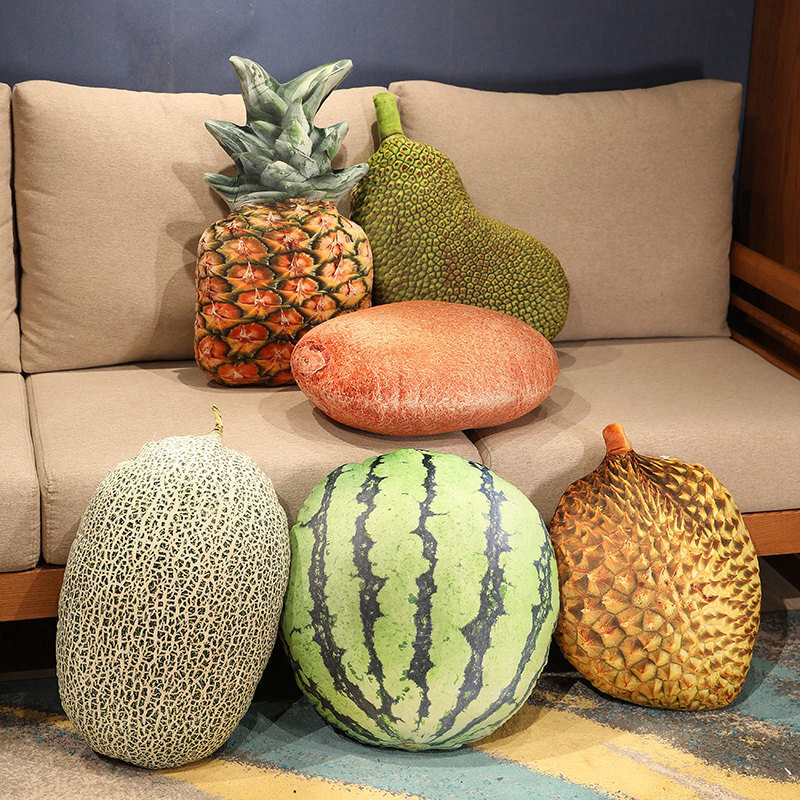 Realistic fruit plush pillows featuring cantaloupe, watermelon, durian, pineapple, and jackfruit on the floor