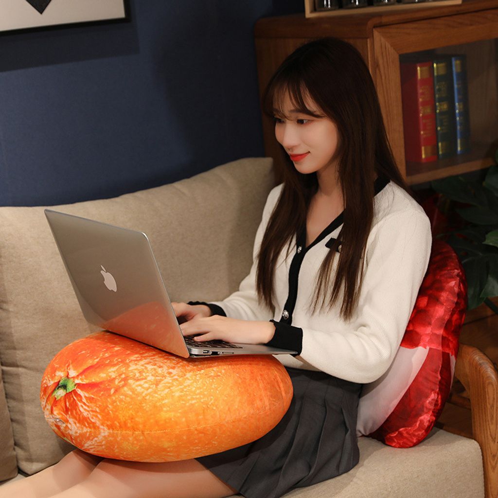 Realistic orange and lychee plush pillows used as soft fruit cushions in a modern living room