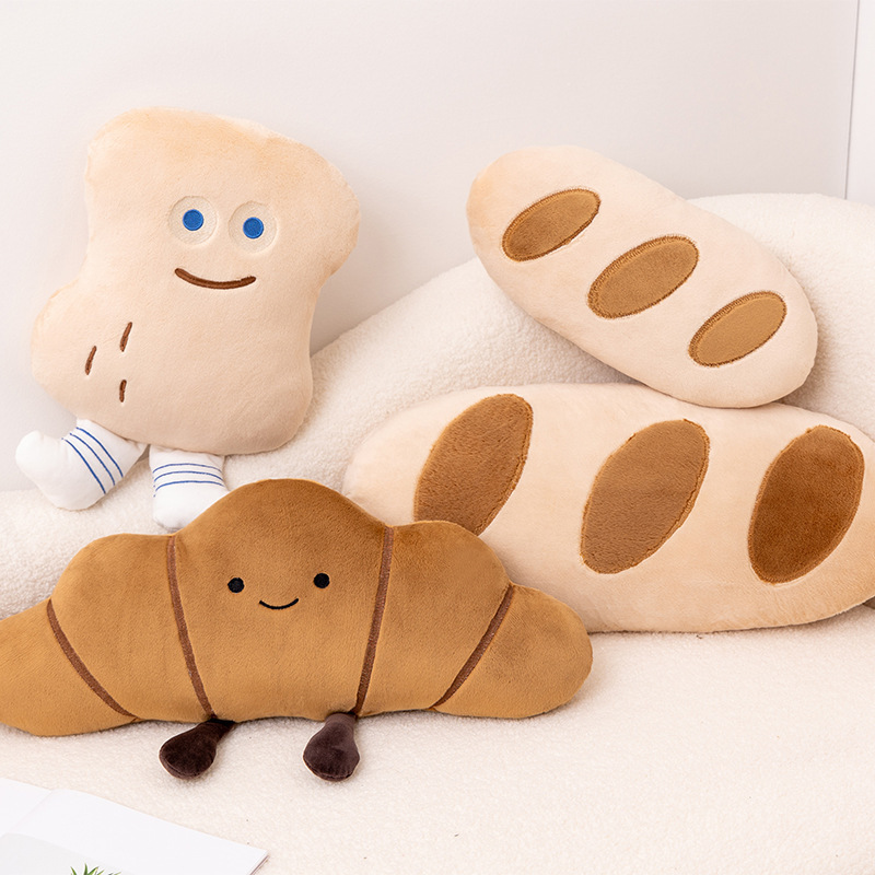 Cute Bread Story plush pillows featuring Baguette, Peanut Bun, and Croissant designs on a sofa