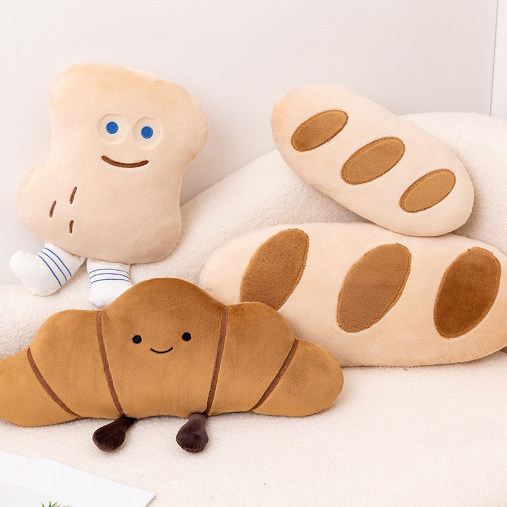 Cute Bread Story plush pillows featuring Baguette, Peanut Bun, and Croissant designs on a sofa