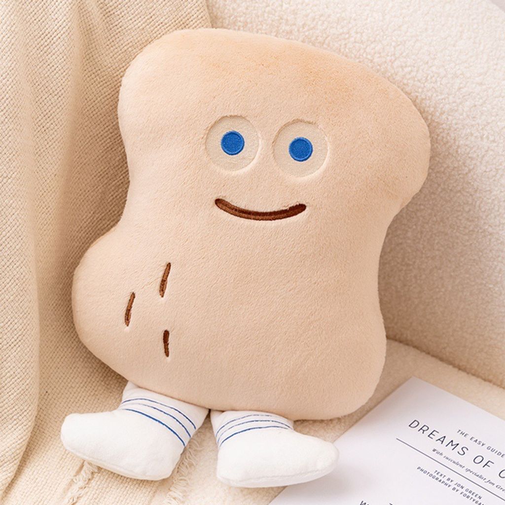 Cute Peanut Bun bread plush pillow sitting on a sofa with book beside it