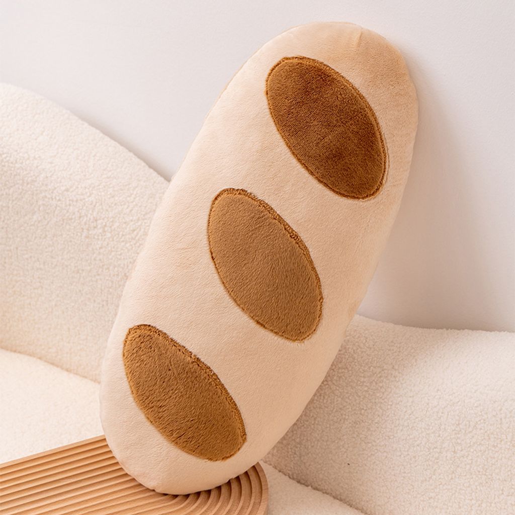 Baguette plush pillow with bread pattern leaning against a sofa