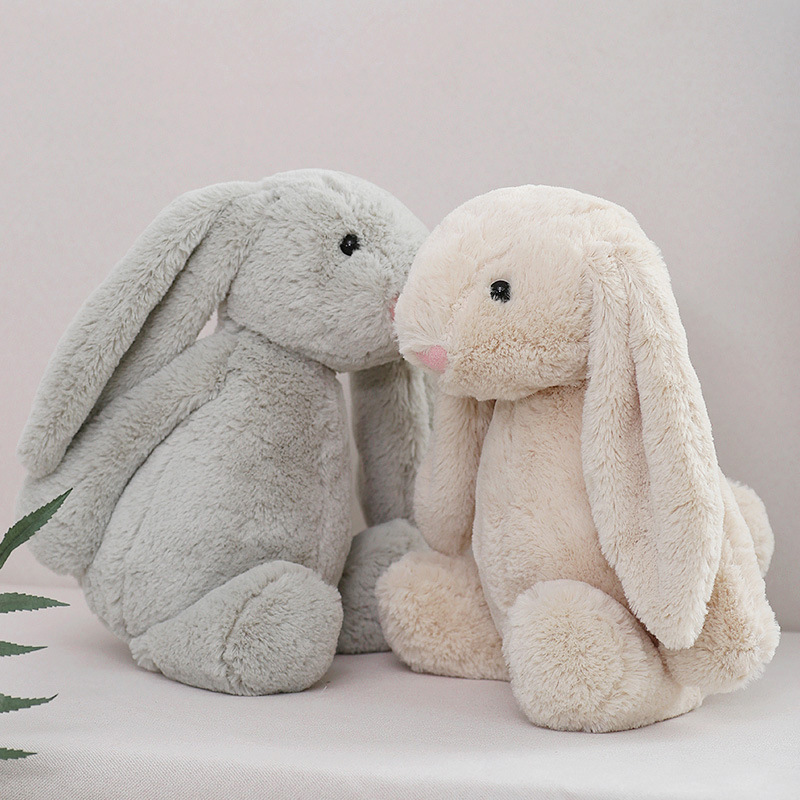 Gray and beige lop ear bunny plush toys sitting together