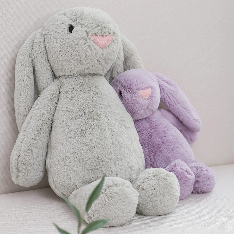 Gray and purple lop ear bunny plush toys in different sizes sitting together