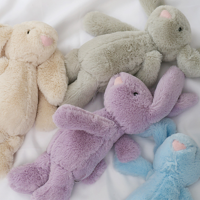 25cm lop ear bunny plush toys in beige, gray, purple and blue on a white fabric background