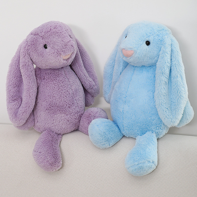 Purple and blue lop ear bunny plush toys sitting side by side