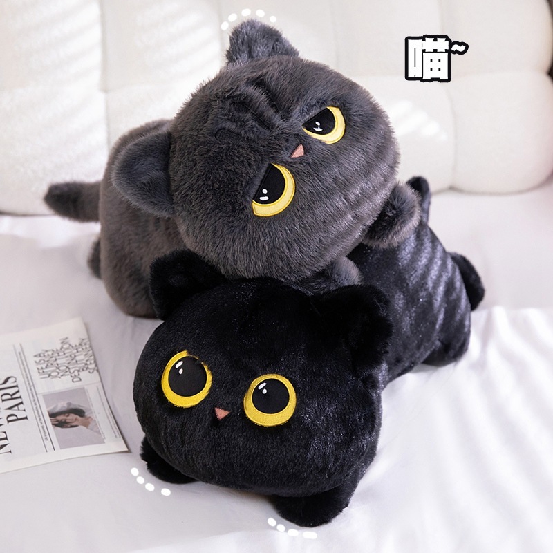 Gray and black lying cat plush pillows on a white bed
