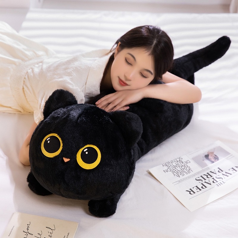 Black lying cat plush pillow used as a soft body pillow for hugging