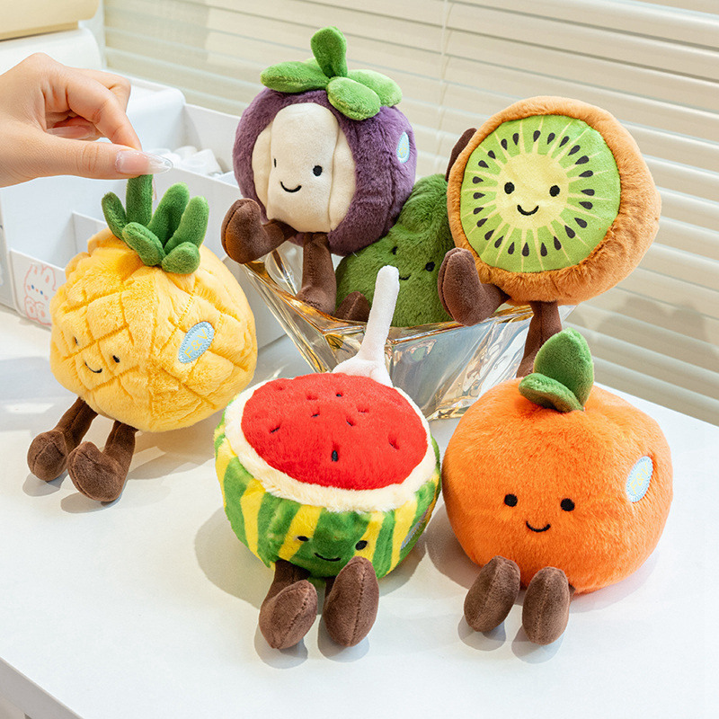 Eco fruit plush toys displayed in a glass bowl on a table