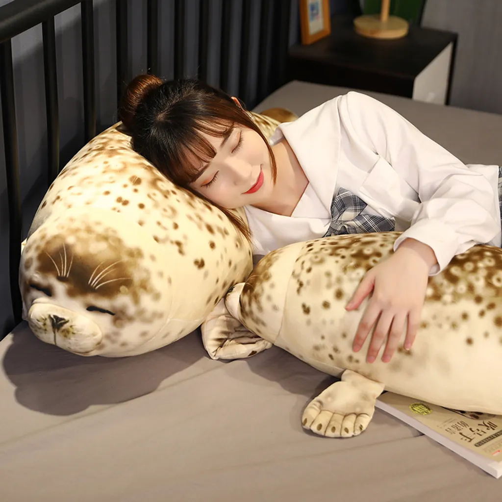 Soft seal plush pillows for cozy sleeping on bed