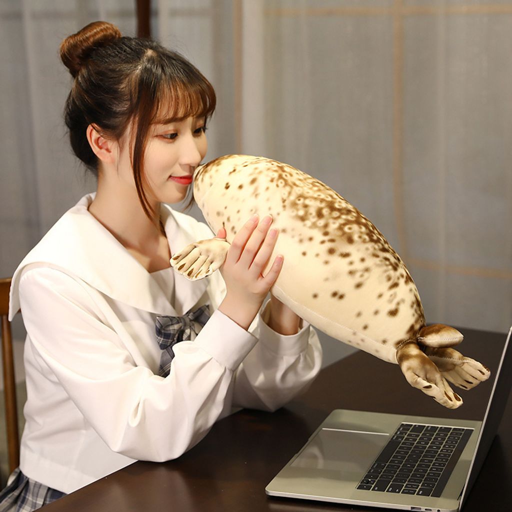 Seal plush pillow used as a cozy desk companion for comfort and relaxation