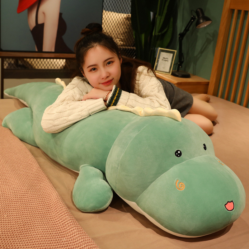 Cute dinosaur plush pillow for hugging and relaxing on the bed