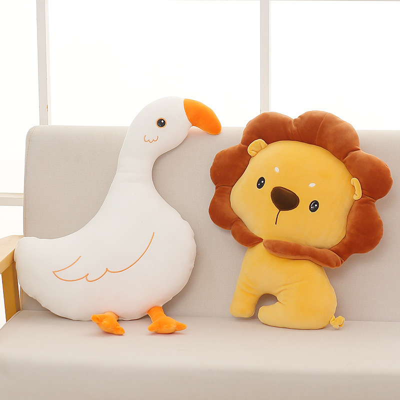Cute goose and lion plush pillows displayed on a sofa in a bright living room