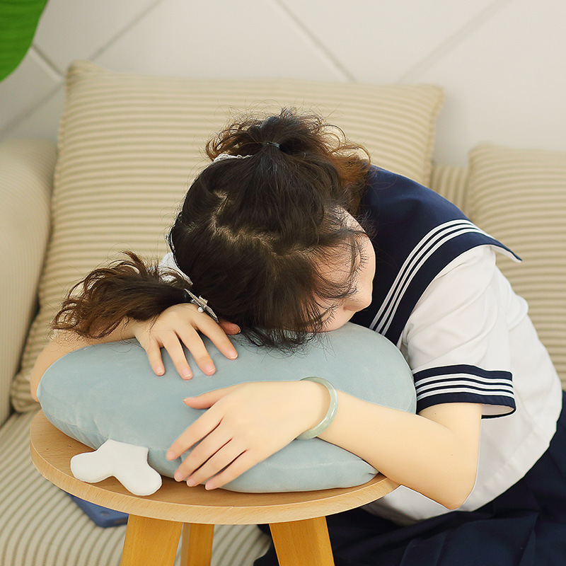 Whale plush pillow used for hugging and relaxing, creating a calm and cozy indoor atmosphere