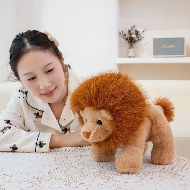 Lion plush toy standing on table with fluffy mane