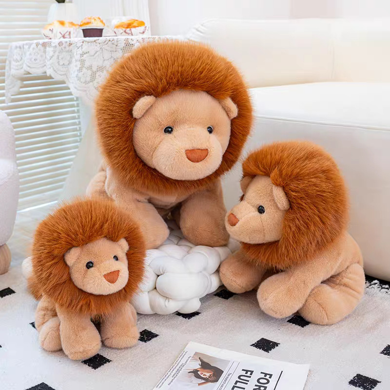 Three lion plush toys in different sizes on living room floor