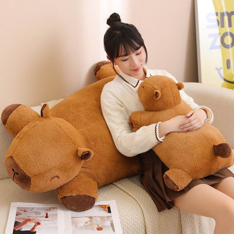 Capybara plush cushion used as a soft back pillow and hugging cushion on a sofa, creating a cozy and relaxing home atmosphere
