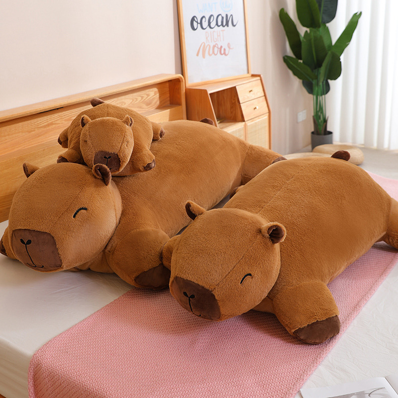 Capybara plush cushion lying on a bed for relaxing and lounging